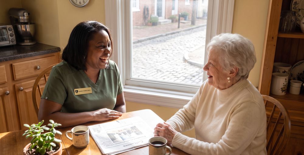 A caregiver and client talking by a sunlit window