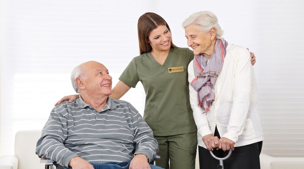 A caregiver with an older couple at home in Towson