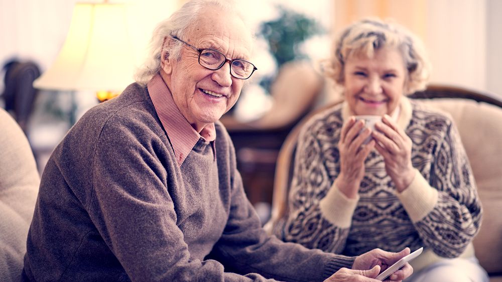 An older couple laughing together at home